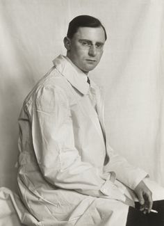 black and white photograph of a man sitting on a chair