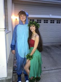 two people dressed up in costumes posing for a photo outside their house with one person wearing a costume