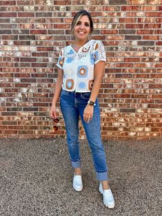 Add some bohemian flair to your wardrobe with our charming crochet top! This vintage-inspired piece features intricate detailing and a button-down front, perfect for warmer days. Embrace elegance with a touch of playfulness in this must-have top. Color: White, Orange and Blue Fabric: 60% Cotton, 40% Acrylic Includes: x1 Top Sizes: S/M, M/L Length: 20" - 20.5"Model is 5'10" and wearing a size small (33-23.5-35) Fall Crochet Top For A Day Out, Casual Blouse With Crochet Lace, Bohemian Blouse With Button Closure For Day Out, Casual Crochet Lace Top For Fall, Casual Cotton Blouse With Crochet Lace, Spring Casual Lace Top For Day Out, Casual V-neck Blouse With Crochet Lace, Casual Lace Top For Spring Day Out, Casual Crochet Lace Top For Spring