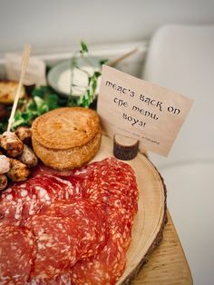 meats and bread on a plate with a sign that says, what's back on the menu?