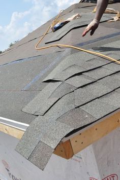 a man working on the roof of a house