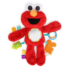 a red stuffed animal with teeth and toys around it's neck on a white background