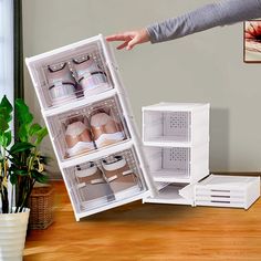 a woman is reaching into an open refrigerator