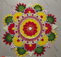 an intricate design on the floor with red, yellow and green flowers