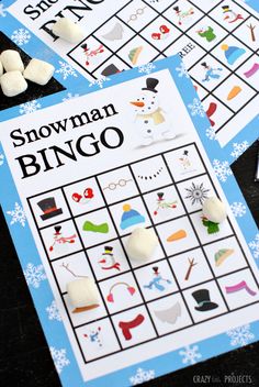 snowman bingo game with marshmallows on the top and other items around it