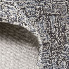 closeup of the texture of a rug with blue and white colors on it, as seen from above