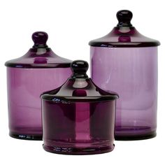 two purple glass jars with lids are shown