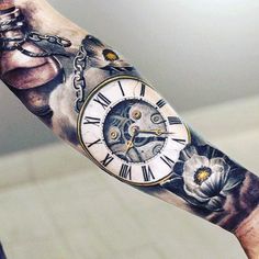 a person with a tattoo on their arm holding a clock and flowers in front of them