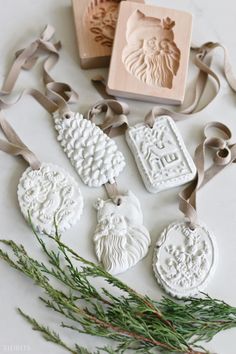 four christmas ornaments with ribbon and rubber stamps