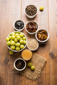 bowls filled with different types of food on top of a wooden table - stock photo - images