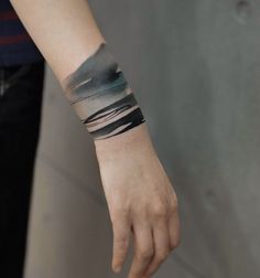 a person with a wrist tattoo on their arm