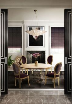 the dining room is decorated in black and white, with gold accents on the table