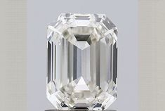 an emerald cut diamond is displayed on a table