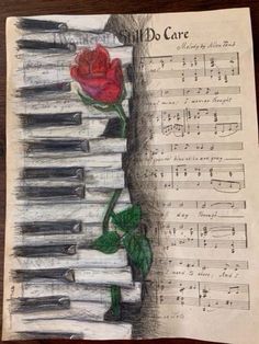 a drawing of a rose sitting on top of sheet music