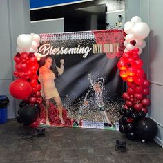 balloons and streamers are set up in front of a backdrop for a concert performance