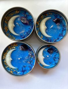 four blue desserts with moon and stars in them