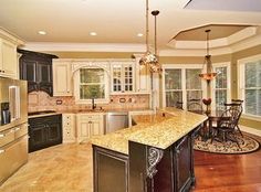 a large kitchen with an island in the middle