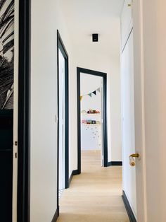 an empty hallway with black and white decor