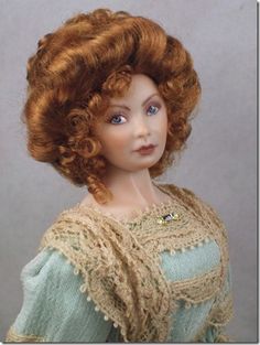 a doll with red hair and blue eyes wearing a lace shawl on her head