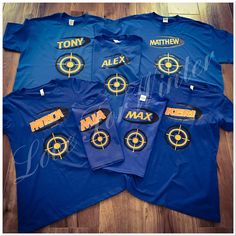 six blue shirts with yellow letters on them