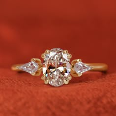 an oval diamond ring with three pear shaped diamonds