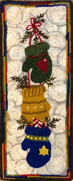 a quilted wall hanging with christmas decorations on it