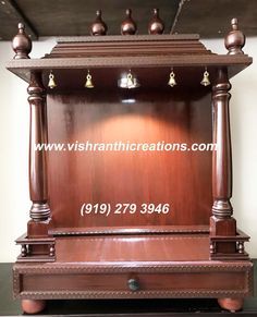 an old wooden clock with bells on it