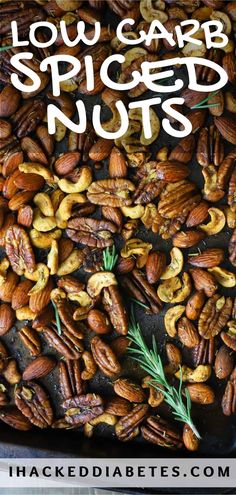 a tray filled with nuts and rosemary garnish on top of it is the title text reads low carb spiced nuts