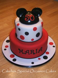 a mickey mouse cake with polka dots and the number 50 on it's top