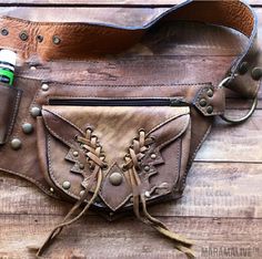 a brown leather purse with two zippers on it