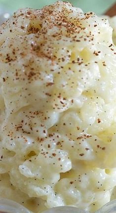 a bowl filled with mashed potatoes and topped with cinnamon sprinkled on top