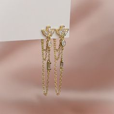 The pair you'll reach for again and again. Add a touch of sparkle to your life with these shimmering gems, designed to complete any look. Handcrafted with a sterling silver base, 14k gold plating and cubic zirconia, these earrings are truly one of a kind. Measuring 40mm in height, they are the perfect accessory to dress up any outfit. Whether you're heading to a party or just running errands, these earrings will add a touch of elegance to your day. Luxury Gold-tone Dangle Linear Earrings, Silver Coat, Gold Plating, Running Errands, Cubic Zirconia, Gold Plate, Dress Up, Plating, Sparkle