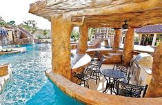 an outdoor dining area next to a pool