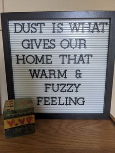 a sign that says dust is what gives our home that warm and fuzzy feeling on it