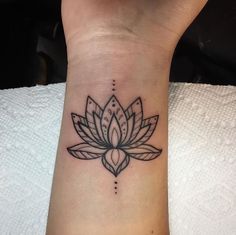 a lotus flower tattoo on the wrist