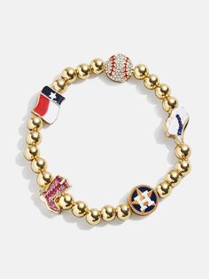 The Houston Astros MLB Pisa Charm Bracelet is the ultimate accessory for die-hard baseball fans. This bracelet is a celebration of your favorite team, featuring the Astros logo along with other charms related to the team and its iconic location. Perfect for game days or everyday wear, this bracelet adds a touch of sports-inspired elegance to any outfit. This bracelet features 6mm gold ball beads. This is an officially licensed MLB product. Sporty Jewelry For Baseball Season Game Day, Sporty Jewelry For Baseball Game Day, Sporty Team-colored Jewelry For Game Day, Sporty Jewelry For Baseball Season, Sporty Jewelry For Game Day, Beaded Charm Bracelet, Family Event, Astros Logo, Baseball Fan