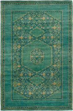 a green rug with an intricate design on the center and sides, in different colors