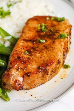 a white plate topped with meat and green beans