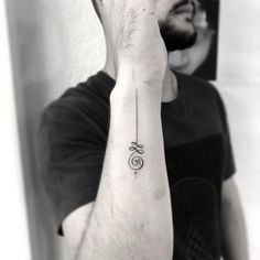 a man with a small tattoo on his arm