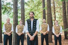 a group of people that are standing in the woods with some kind of vests