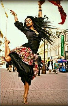 a woman is dancing on the street