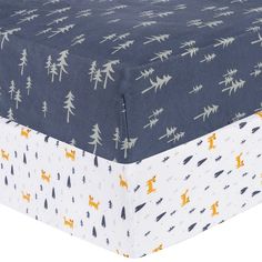 an image of a blue and white bed sheet with yellow animals on the bottom half