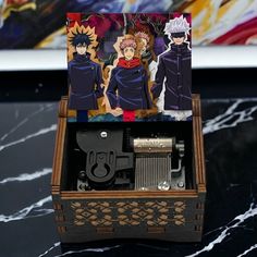 an open wooden box with anime characters on it