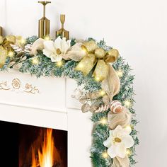 a fireplace decorated for christmas with gold and white decorations