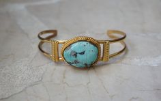 Vintage Mid-Century Circa 1960 in an Ancient Roman Style Constructed of Sterling Silver Accented with a Gold Plating / Vermeil  with 1 Bezel set piece of Genuine Earth-Mined Natural Turquoise Fitting up to a 6.5" Wrist Weighing 20.3 grams --Pictured on a 6" Wrist in natural daylight/sunlight--  *Sale of bracelet includes an appraisal certificate for your insurance purposes.  All pieces shipped insured via USPS Priority Mail requiring signature upon delivery.  Specialty gift wrap upon request at Roman Style, Roman Fashion, Turquoise Bracelet Cuff, Turquoise Cuff, Sterling Silver Cuff Bracelet, Ancient Romans, Sterling Silver Cuff, Silver Cuff Bracelet, Natural Turquoise