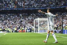 the soccer player is celebrating his team's victory over the crowd in front of him