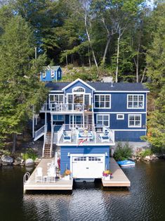 a blue house sitting on top of a lake