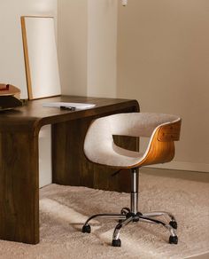 a desk with a chair and a mirror on it in the corner of a room