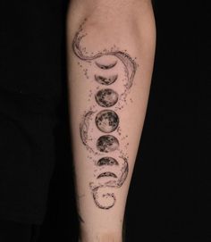 a man's arm with phases of the moon and stars tattoo design on it