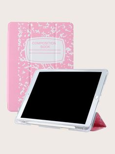 the pink composition book is next to an ipad